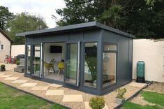 a small garden room with sliding glass doors