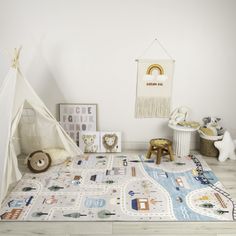 a child's playroom with a teepee tent and toys on the floor