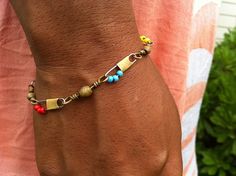 a person wearing a bracelet with beads on it