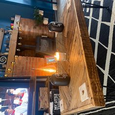 a wooden table sitting next to a tv on top of a blue carpeted floor