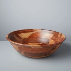 a wooden bowl sitting on top of a table