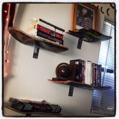 two shelves with books and other items on them