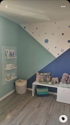 a child's room with blue and green walls, white furniture and polka dots on the wall