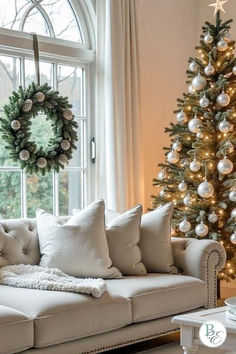 a living room filled with furniture and a christmas tree in front of a large window