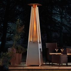 an outdoor patio heater lit up at night