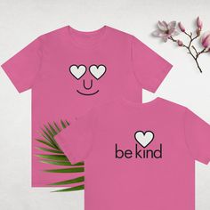 Soft cotton modern design T-shirt in pink with black and white emoji smile art on the front and a Be Kind message on the back. You'll love this for Pink Shirt Day, Valentine's Day or all year long. It's a great way to spread the anti-bullying message in all languages. This classic unisex jersey short sleeve tee fits like a well-loved favorite. We produce these with Bella+Canvas because of their solid reputation in quality and treatment of workforce. These t-shirts have-ribbed knit collars to bol Black And White Emoji, White Emoji, Pink Shirt Day, Emoji Smile, Smile Art, Modern Heart, Happy Valentine's Day, Happy Valentine's, Pink Shirt