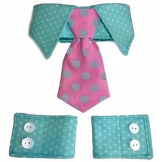 a pink and blue polka dot tie with matching cuff links, two white buttons on each side