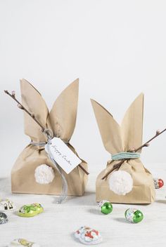 two brown bags filled with candy sitting on top of a table