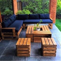 an outdoor patio with wooden furniture and blue cushions