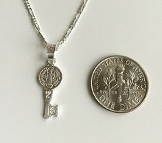 "925 STERLING SILVER SAINT BENEDICT KEY NECKLACE . 20\" LONG FÍGARO CHAIN. FOR GOOD LUCK ,PROSPERITY AND PROTECTION. PENDANT SIZE 22 mm X 8 mm CADENA DE 925 PLATA ESTERLINA SAN BENITO LLAVE. CADENA 20\" LARGO FIGARO. PARA BUENA SUERTE ,PROSPERIDAD Y PROTECCIÓN... TAMAÑO DEL DIJE : 22 mm X 8 mm" Silver Key Pendant Jewelry, Silver Key Necklace For Gift, Good Luck Silver Engraved Charm Necklaces, Silver Engraved Charm Necklace For Good Luck, Good Luck Silver Engraved Charm Necklace, Good Luck Engraved Silver Charm Necklace, Silver Necklace With Two Keys For Gift, Silver Pendant Necklace With Two Keys, Silver Key Pendant Necklace