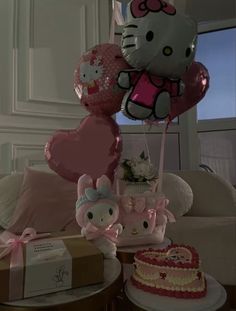 hello kitty balloons and other items on a table