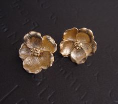 Mother Earrings, GOLD Magnolia Earrings, Stud Flower Earrings, Bridesmaid Gift Ideas, Mother Day from Daughter, Bridesmaid Earrings Beautiful set earrings of golden magnolia flower made of matte gold plated. These earrings come with .925 sterling silver post. Measurement Dimensions - 19.5mm These earrings are available in SILVER. Please leave a note at Check out if you want to purchase SILVER instead Matching Necklace https://www.etsy.com/listing/175334618/gold-magnolia-necklace-flower-pendant S Vintage Gold Flower Earrings For Wedding, Vintage Gold Flower Earrings For Gift, Nickel-free Gold Flower Earrings For Wedding, Handmade Gold Bridal Earrings As Bridesmaid Gift, Nickel-free Gold Clip-on Earrings For Weddings, Gold Flower Earrings For Bridesmaid Gift, Handmade Gold Earrings For Bridesmaid Gift, Handmade Gold Earrings For Bridesmaids, Gold Flower Bridal Earrings For Anniversary