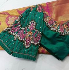 Peacock motifs inspired Maggam work blouse with Zari, Kundan, Beads and pearls work. This blouse can be made in any other color of your choice. Note - Doris and Latkans provided are complementary so please do not complain about them. We do our best to put best latkans for you. Disclaimer - Actual colors may vary slightly due to computer monitors displaying settings. We try hard to match exact color. For sizes 42+ we charge extra $20 for fabric and workmanship. Please contact us before placing or Wedding Green Blouse Piece With Motifs, Green Handwork Saree Blouse Piece, Green Blouse With Handwork For Festivals, Green Handwork Blouse For Wedding, Elegant Green Blouse For Puja, Elegant Motif Blouse For Puja, Elegant Blouse With Motifs For Puja, Green Handwork Saree For Wedding, Traditional Green Blouse With Motifs