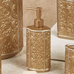 gold bathroom accessories including soap dispenser, toothbrush holder and tissue dispenser