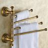 a towel rack with four towels hanging on it's sides and two gold handles