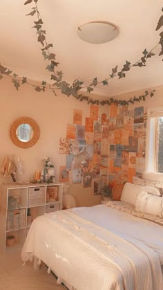 a bed sitting in a bedroom next to a window with lots of pictures on the wall