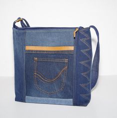 "Blue bag made of recycled jeans. The material is cleaned and restored. The bag is made from different pieces of old jeans and leather. There are pockets on the front and back. It is medium in size and lined with cotton fabric. They have pockets inside. The bag closes with a zipper. The bag is washable. The handle is adjustable. This bag can be worn on the shoulder and over the body, depending on the selected handle length. SIZE Height: 32 (12.50\") Width:  36cm  (14.17\") Depth:  11cm   ( 4.33\") Each piece that you will find in the collection is made one at a time, with carefully selected materials, and most styles are created in very small runs according material availability. Handmade in our Most na Soci studio - Real colors may differ slightly from their appearance on your display. - Denim Bag Patterns, Recycle Bag, Recycled Jeans, Denim Ideas, Jeans Bag, Old Jeans, Recycled Denim, Denim Bag, Medium Bags