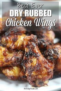 baked or grilled dry rubbed chicken wings on a white plate with text overlay