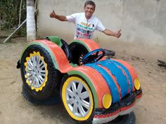 a man standing next to a colorful toy car