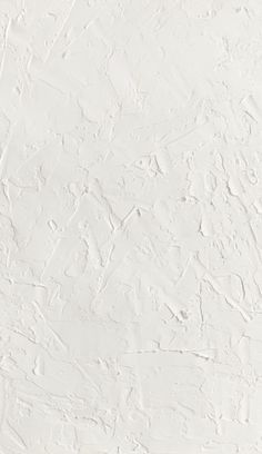 a white wall that has been painted with some paint on it and is very textured