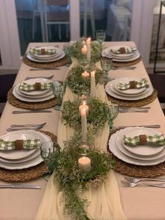 the table is set with place settings for dinner