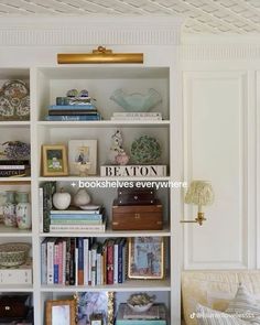 a white bookcase filled with lots of books