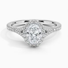 an oval cut engagement ring with diamond shoulders