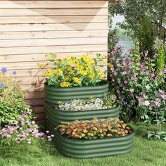 three tiered garden planters in front of a wooden building with flowers growing out of them