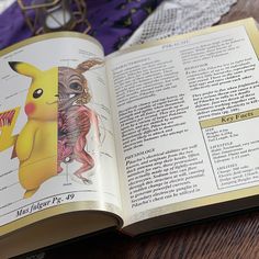 an open book with pictures of pokemons and other things in it on a table