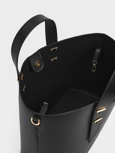 This product is made with at least 20% sustainable materials by weight. CHARLES & KEITH uses recycled, degradable, organic, and water-based materials in our eco-conscious collection. Whatever the season, you can rely on this all-black bag to complement every ensemble in your wardrobe. Designed with thick double handles, this bag is the ideal grab-and-go piece. It is just as comfortable to carry it in the palm of your hand and on the crook of your arm. This piece also comes with an additional adjustable shoulder strap that offers more styling options -- use it as a shoulder bag or a crossbody bag, the choice is yours. Bonus points for the additional inner pouch that offers more storage space. Palm Of Your Hand, Charles Keith, Black Metallic, The Palm, Black Bag, Sustainable Materials, Eco Conscious, Black Tote Bag, Metallic Accents