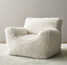 a white chair sitting on top of a rug