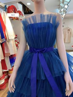 a mannequin wearing a blue dress in a store