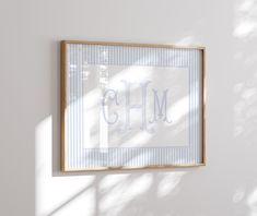 a wooden frame hanging on the wall above a framed monogrammed art piece that reads, oh