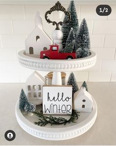 two tiered trays with christmas decorations on them and a sign that says hello winter