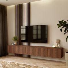 a flat screen tv mounted to the side of a wooden entertainment center in a living room