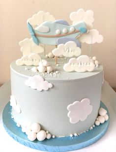 a blue and white cake with clouds on top