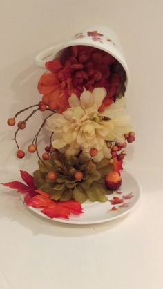 a white plate topped with flowers and leaves