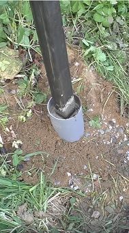 an image of a pipe in the ground with dirt around it and grass growing on the ground