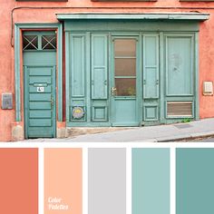 an old building with blue doors and green shutters on the outside, along with pink walls