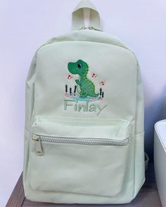 Our New Range of Beautifully Embroidered Backpacks in a range of colours  Personalised with design and first name in any colour thread. Backpack Size : 35 x 23 x 12 cm Capacity : 7 litres There are 4 different colours available, and all have: Grab handle. Padded adjustable shoulder straps. Padded back panel. Main zip compartment. Front zip pocket The bag can either be embroidered with just the name in a choice of fonts and colours, or with the large size initial and name in a choice of colour/fo Cute Green Backpack With Zipper Closure, Cute Green Backpack For Students, Cute Green Student Backpack, White School Bags With Letter Embroidery, Cute Green Backpack For Back To School, Trendy Embroidered Backpack, Green Embroidered School Bag, Trendy Embroidered School Backpack, Backpack With Letter Embroidery For Everyday Use