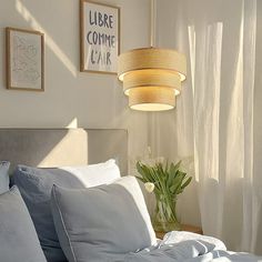 a bed with white sheets and blue pillows