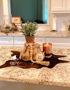 a kitchen counter with a candle holder on top of it and a potted plant in the middle