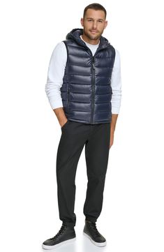 Easy to layer, this puffer-style vest features an attached hood that furthers the comfort. Attached hood Sleeveless 100% polyester Machine wash Imported Model stats: 6'1" height, 32" waist. Model is wearing size M. Casual Fall Vest With Detachable Hood, Casual Nylon Vest With Padded Collar, Nylon Outerwear With Detachable Hood, Fitted Casual Puffer Jacket For Outdoor Activities, Casual Nylon Vest For Workwear, Sleeveless Nylon Outerwear With Detachable Hood, Sleeveless Down Puffer Vest, Sporty Sleeveless Puffer Outerwear, Casual Sleeveless Puffer Outerwear