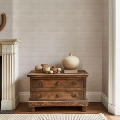 a wooden dresser sitting next to a fire place