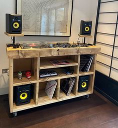 an entertainment center made out of pallet wood with speakers on each side and bookshelf