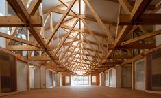 an empty room with wooden beams and windows