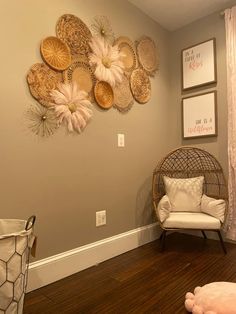 a living room filled with furniture and pictures hanging on the wall above it's wood flooring