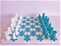 a chess board made out of white and blue puzzle pieces