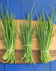 green onions are laid out on a cutting board