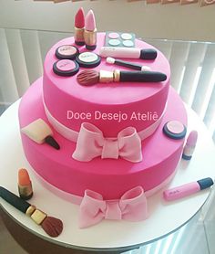 there is a pink cake with makeup on it